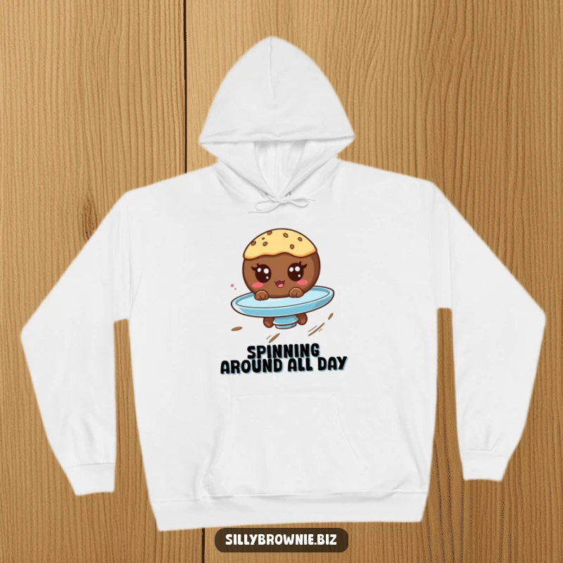 Funny hoodie featuring a round brownie character with googly eyes spinning on a plate, perfect for a dizzying good time.