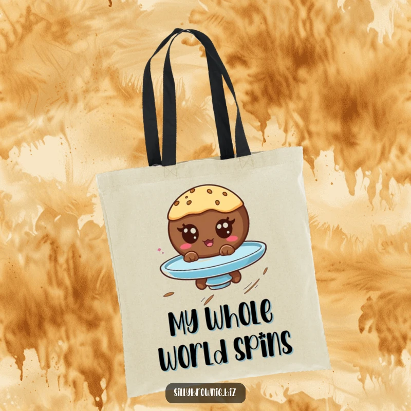 Funny tote bag showcasing a round brownie character with googly eyes spinning on a plate, perfect for carrying humor.